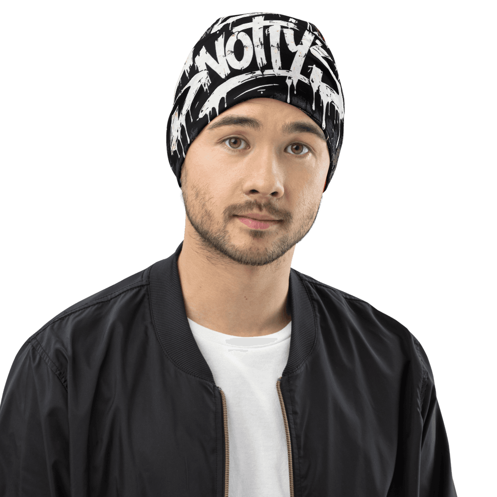 All-over print beanie covered in neon Snotty's graffiti tags, a boombox, and spray-paint splatter